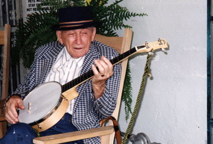 Howard Finster posing with a banjo