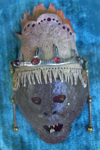   "Seer"   c. 2011  by Michael Whalton Avocado leather, fish leather, European glass, sculptor's metal, brass findings, flounder teeth, enamel paint & diamond   5" x 3"  $2800   #11291