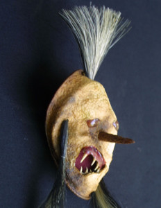 detail  “Booger Mask Minature” c. 2012 by Michael Whalton Mixed media, Ox hair, citrus leather, flounder teeth, cedar cone heart & diamonds 7.5″ x 2.5″ x 2.5 $3200 #11294