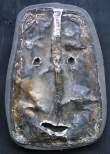 A metal sculpture of a face 5
