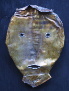 A metal sculpture of a face 4