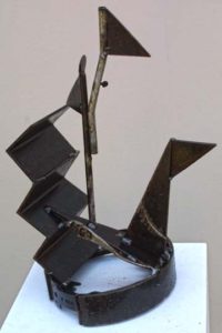 A small metal sculpture of a boat or ship
