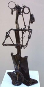 Metal sculpture of a person with a cane