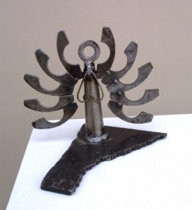 A metal sculpture of a being with many hands