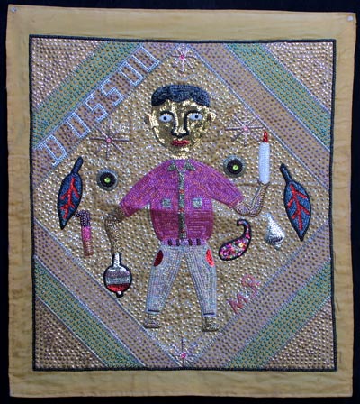 A piece of embroidery with a man holding an object.