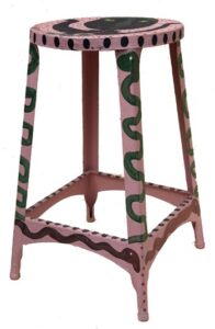 A pink stool with snake designs  