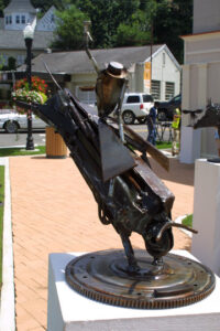 Metal sculpture of a man on a grasshopper