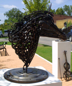 A metal sculpture of a head of a horse