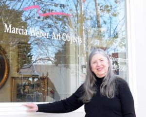 Marcia Weber in front of the gallery
