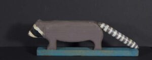 "Racoon" by Braxton Ponder mixed media on carved wood 4.5" x 1.5" x 13.5" $200 #13386