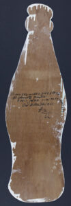 "Coke Bottle" dated Feb. 1, 1990 by Howard Finster paint, marker on shaped wood 24" x 11.5" $3000 #13622