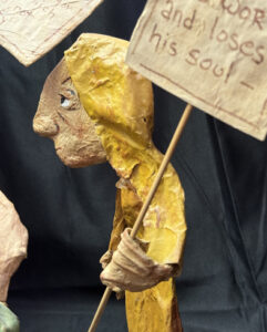 detail yellow figure "Three Wisemen--Fools"  c. 1991 by Hope Atkinson  (3 figures with two signs)papier mache & paint with found metal spring  tallest figure 7"  $1400  #13734