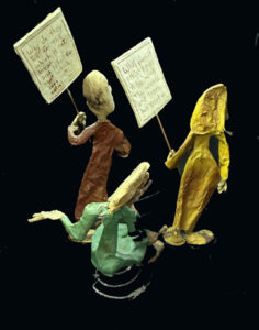 back "Three Wisemen--Fools"  c. 1991 by Hope Atkinson  (3 figures with two signs)papier mache & paint with found metal spring  tallest figure 7"  $1400  #13734