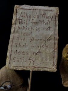 sign of brown figure "Three Wisemen--Fools"  c. 1991 by Hope Atkinson  (3 figures with two signs)papier mache & paint with found metal spring  tallest figure 7"  $1400  #13734