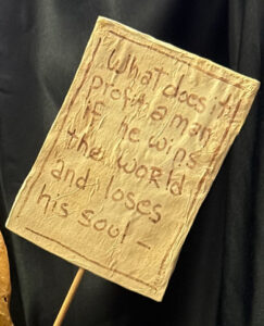 sign of yellow figure "Three Wisemen--Fools"  c. 1991 by Hope Atkinson  (3 figures with two signs)papier mache & paint with found metal spring  tallest figure 7"  $1400  #13734